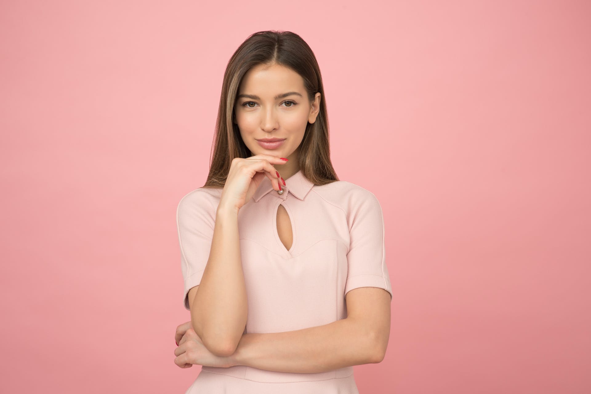 Picture of Amy's in business atire with a pink background